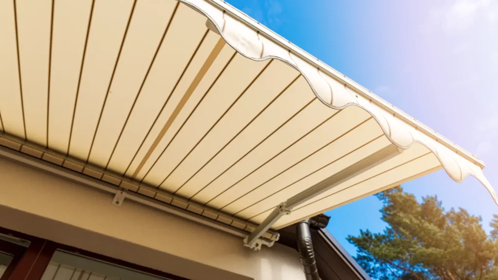 An awning over a house with a blue sky.