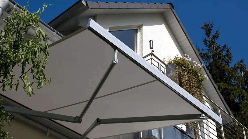 A white awning on the side of a house.