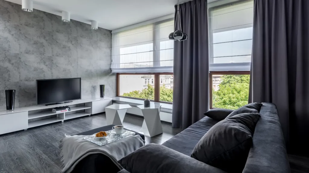 Modern living room with grey walls and a tv.