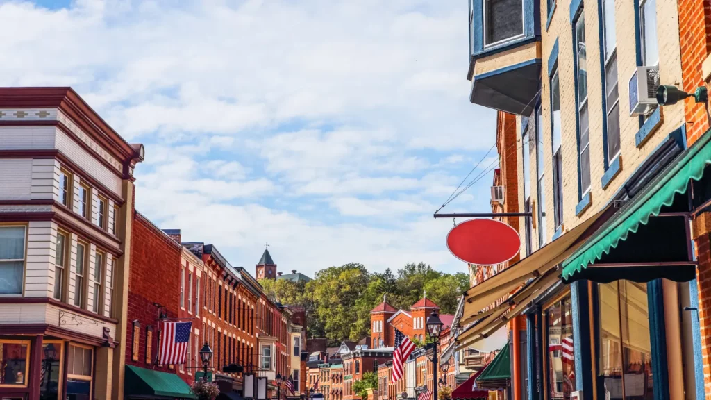 A street in a town with many shops and restaurants.