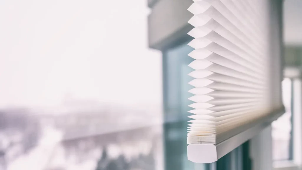 A view of a window with blinds on it.