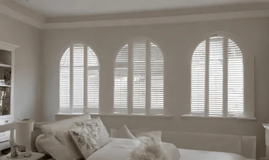 White shutters on arched windows.