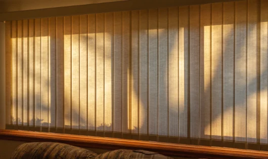 A large window with fabric vertical blinds.
