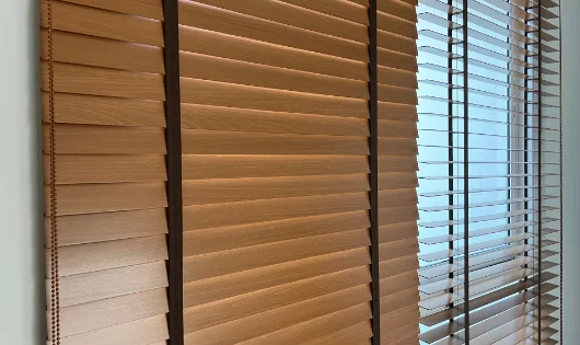 A window with elegant wooden blinds.