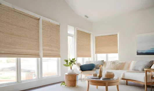 A living room with natural woven wood shades.