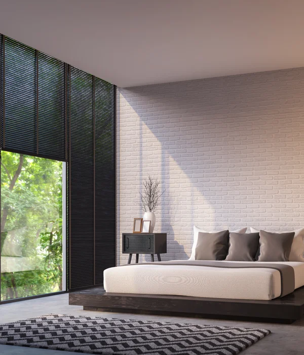 A modern bedroom with a large window and a black bed.