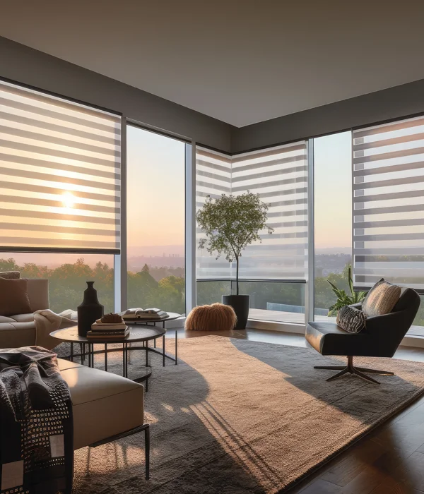 A living room with a large window overlooking the sunset.