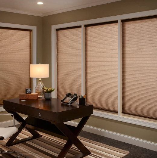 Woven shades in a home office.