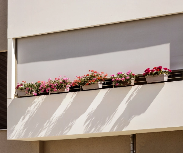 A large outdoor roller shade on a balcony.