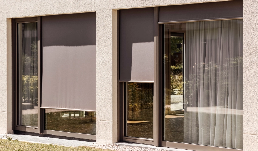 Outdoor roller shades of various sizes on a house.