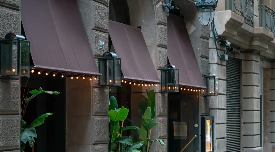 Gray lighted awnings outside a hotel.