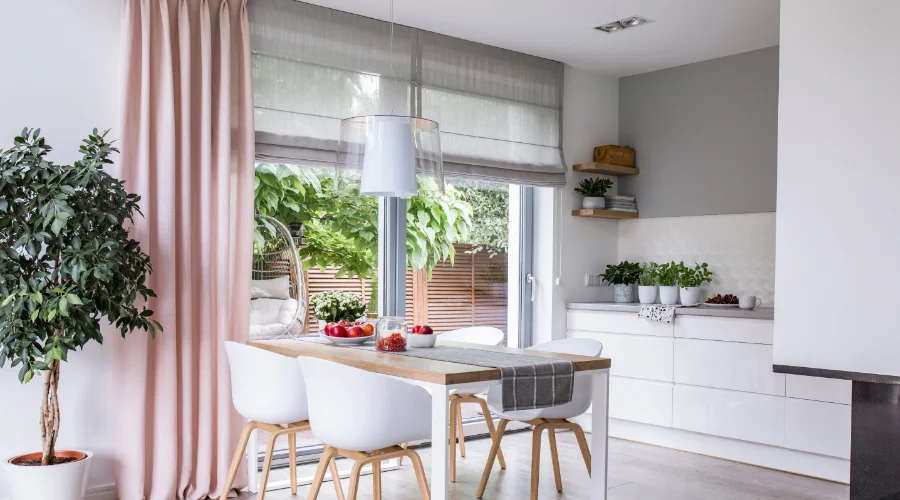 Roman shades in a kitchen dining area.