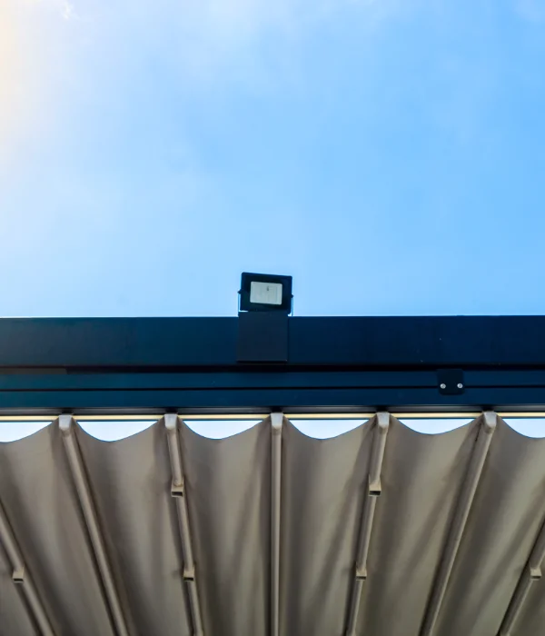 A slide-wire cable awning on a blue frame.