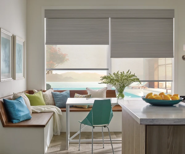 Roller shades in a kitchen and seating area.