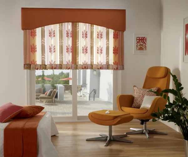 A bedroom with motorized floral curtains.