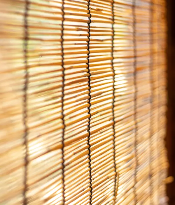 A close up of a window with matchstick shades.