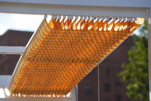 A white and orange slide wire cable awning.