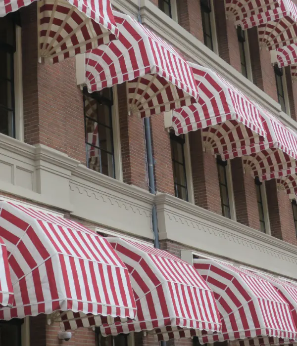 Red and white candy striped dome awnings on a commercial building.