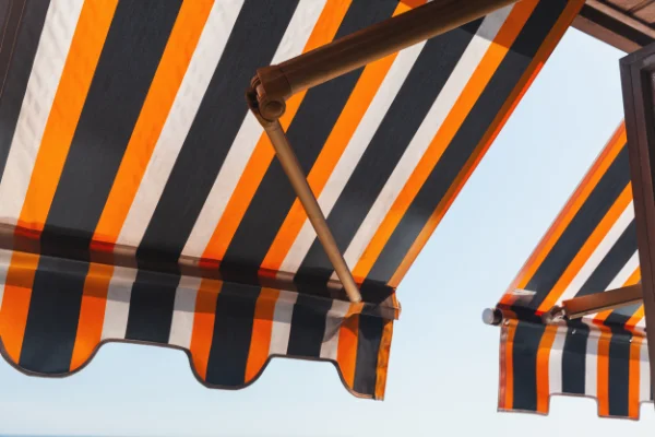 An orange and black striped retractable awning.