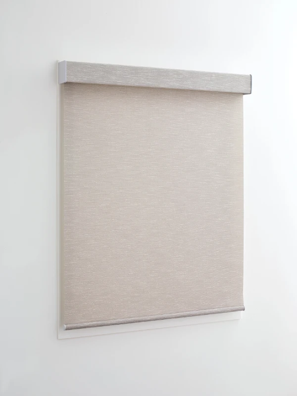 A beige roller shade covering a narrow window.