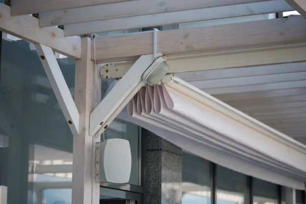 A white clide-wire cable awning covering a patio.