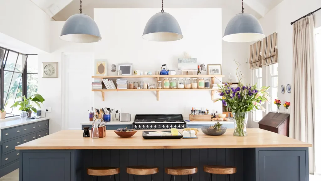 A kitchen with blue cabinets and wooden stools.