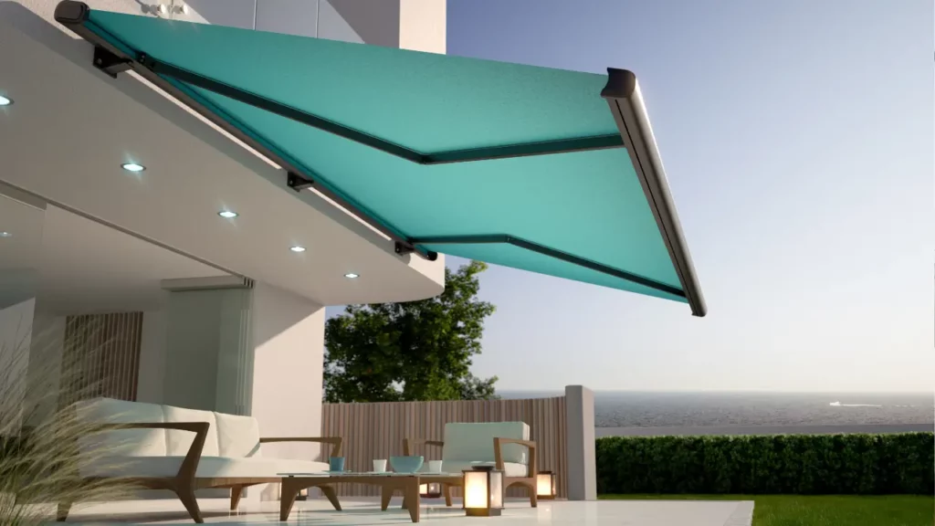 An outdoor patio with a teal retractable awning.