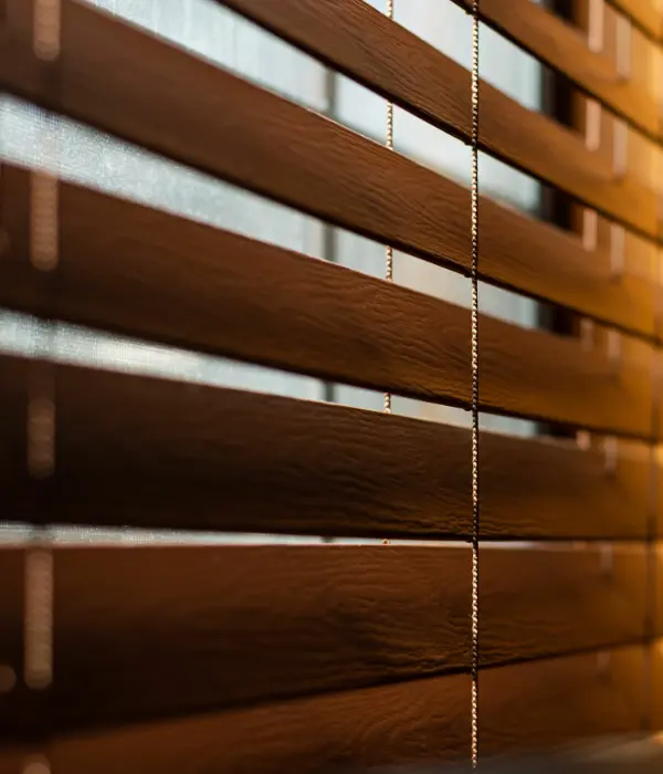 A close up of wooden blinds in a window.
