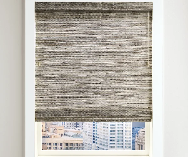A window with a partially lowered woven shade