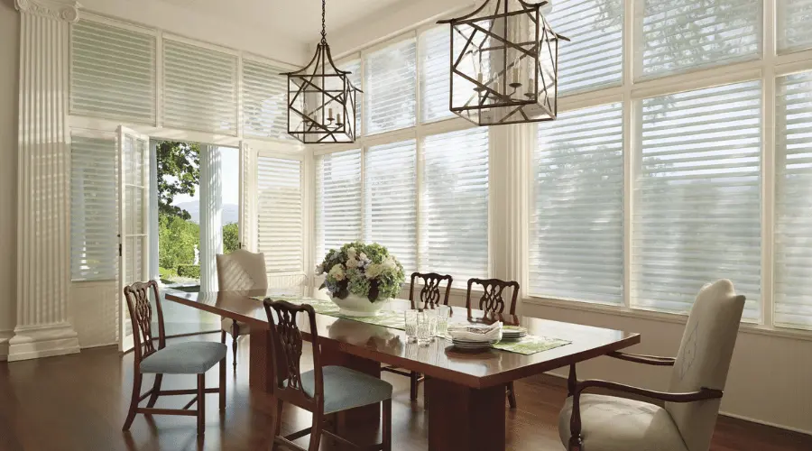 A dining room with silhouette shades