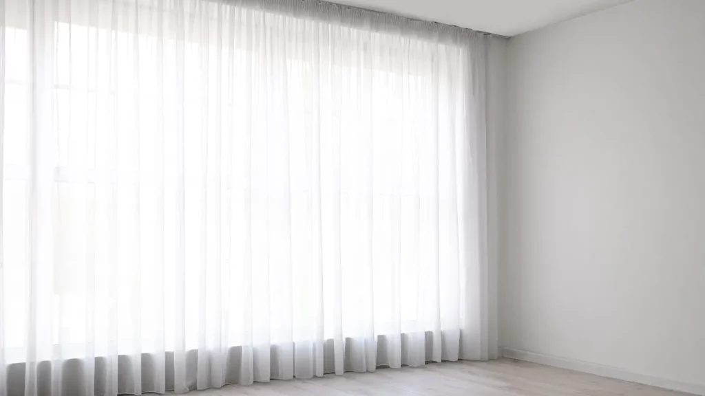 Sheer curtains covering a wide window